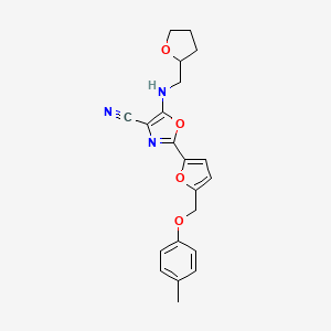 2-{5-[(4-Methylphenoxy)methyl]furan-2-yl}-5-[(tetrahydrofuran-2-ylmethyl)amino]-1,3-oxazole-4-carbonitrile