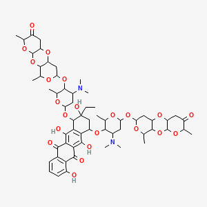 B1202636 10-[4-(Dimethylamino)-5-[(5,14-dimethyl-6-oxo-2,4,9,13-tetraoxatricyclo[8.4.0.03,8]tetradecan-12-yl)oxy]-6-methyloxan-2-yl]oxy-7-[4-(dimethylamino)-6-[(5,14-dimethyl-6-oxo-2,4,9,13-tetraoxatricyclo[8.4.0.03,8]tetradecan-12-yl)oxy]-2-methyloxan-3-yl]oxy-9-ethyl-4,6,9,11-tetrahydroxy-8,10-dihydro-7H-tetracene-5,12-dione CAS No. 87385-19-1