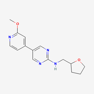 5-(2-methoxypyridin-4-yl)-N-[(oxolan-2-yl)methyl]pyrimidin-2-amine