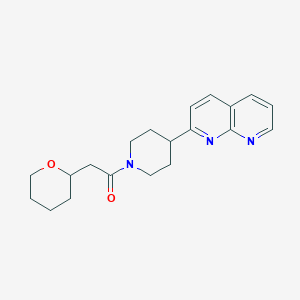 1-[4-(1,8-Naphthyridin-2-yl)piperidin-1-yl]-2-(oxan-2-yl)ethan-1-one