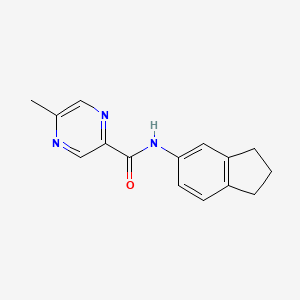 molecular formula C15H15N3O B1224332 N-(2,3-Dihydro-1H-inden-5-yl)-5-methyl-2-pyrazinecarboxamide 