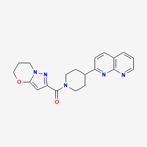 2-(1-{5H,6H,7H-pyrazolo[3,2-b][1,3]oxazine-2-carbonyl}piperidin-4-yl)-1,8-naphthyridine