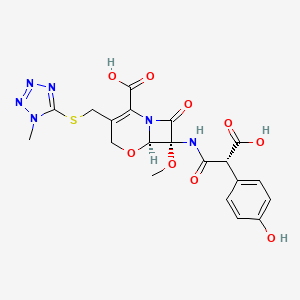 molecular formula C20H20N6O9S B1232316 7-((Carboxy(4-hydroxyphenyl)acetyl)amino)-7-methoxy-(3-((1-methyl-1H-tetrazol-5-YL)thio)methyl)-8-oxo-5-oxa-1-azabicyclo[4.2.0]oct-2-ene-2-carboxylic acid 