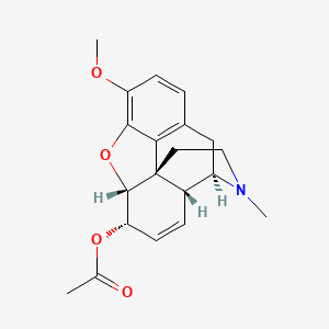 molecular formula C20H23NO4 B1236443 [(4R,4aR,7S,7aR,12bS)-9-methoxy-3-methyl-2,4,4a,7,7a,13-hexahydro-1H-4,12-methanobenzofuro[3,2-e]isoquinolin-7-yl] acetate CAS No. 6703-27-1