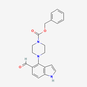 molecular formula C21H21N3O3 B12637560 4-[4-(Benzyloxycarbonyl)piperazino]-1H-indole-5-carbaldehyde 