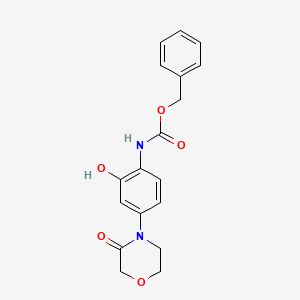 molecular formula C18H18N2O5 B12826483 Benzyl (2-hydroxy-4-(3-oxomorpholino)phenyl)carbamate 