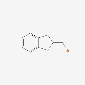 B1289450 2-(Bromomethyl)-2,3-dihydro-1H-indene CAS No. 348080-87-5