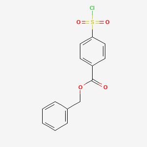 molecular formula C14H11ClO4S B13031890 Benzyl4-(chlorosulfonyl)benzoate 