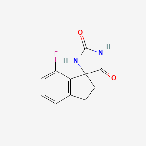 molecular formula C11H9FN2O2 B13032608 7'-Fluoro-2',3'-dihydrospiro[imidazolidine-4,1'-indene]-2,5-dione 