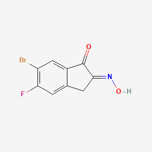 (E)-6-Bromo-5-fluoro-2-(hydroxyimino)-2,3-dihydro-1H-inden-1-one