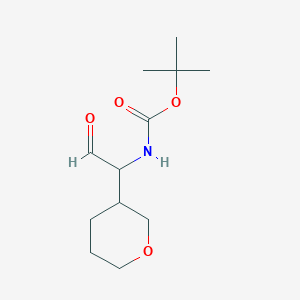 molecular formula C12H21NO4 B13261538 tert-Butyl N-[1-(oxan-3-yl)-2-oxoethyl]carbamate 