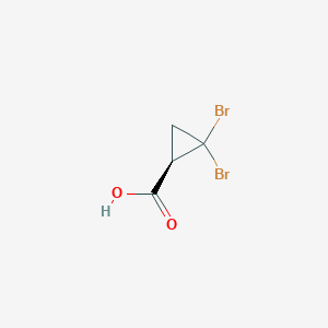 (1R)-2,2-Dibromocyclopropane-1-carboxylic acid