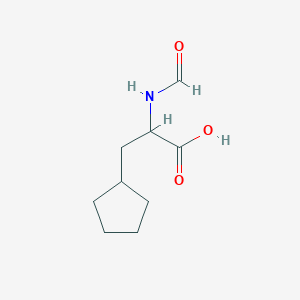 molecular formula C9H15NO3 B13538200 3-Cyclopentyl-2-formamidopropanoic acid 