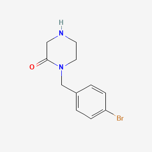 1-[(4-Bromophenyl)methyl]piperazin-2-one