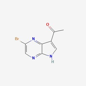 molecular formula C8H6BrN3O B13677252 1-(2-Bromo-5H-pyrrolo[2,3-b]pyrazin-7-yl)ethanone 