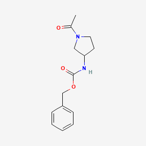 molecular formula C14H18N2O3 B13686916 1-[3-(Cbz-amino)-1-pyrrolidinyl]ethanone 