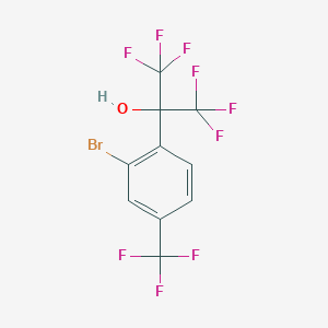 molecular formula C10H4BrF9O B13696162 2-[2-Bromo-4-(trifluoromethyl)phenyl]-1,1,1,3,3,3-hexafluoro-2-propanol 