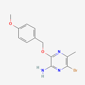 molecular formula C13H14BrN3O2 B13700105 2-Amino-6-bromo-3-[(4-methoxybenzyl)oxy]-5-methylpyrazine 