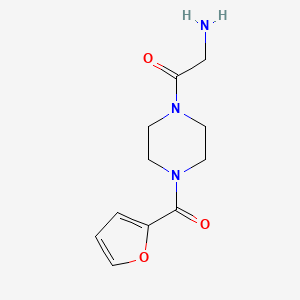 molecular formula C11H15N3O3 B1370344 2-Amino-1-[4-(furan-2-carbonyl)piperazin-1-yl]ethan-1-one 