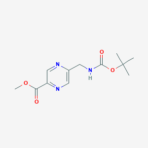 molecular formula C12H17N3O4 B13707068 Methyl 5-[(Boc-amino)methyl]pyrazine-2-carboxylate 