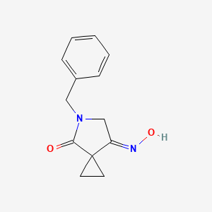 molecular formula C13H14N2O2 B1373948 (E)-5-苄基-7-(羟亚氨基)-5-氮杂螺[2.4]庚烷-4-酮 CAS No. 129306-06-5