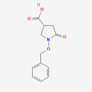 molecular formula C12H13NO4 B1375878 1-(Benzyloxy)-5-oxopyrrolidine-3-carboxylic acid CAS No. 99940-64-4