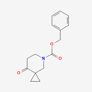 molecular formula C15H17NO3 B1376055 苯甲酸苄酯 8-氧代-5-氮杂螺[2.5]辛烷-5-羧酸酯 CAS No. 1232542-21-0