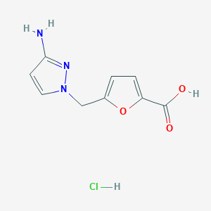 molecular formula C9H10ClN3O3 B1381002 5-[(3-Amino-1H-pyrazol-1-yl)methyl]-2-furoic acid hydrochloride CAS No. 1431963-63-1