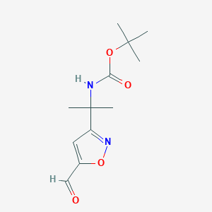 molecular formula C12H18N2O4 B1382550 tert-butyl N-[2-(5-formyl-1,2-oxazol-3-yl)propan-2-yl]carbamate CAS No. 1803595-41-6