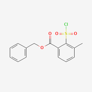 molecular formula C15H13ClO4S B13847028 Benzyl 2-(Chlorosulfonyl)-3-methylbenzoate 