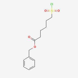 molecular formula C13H17ClO4S B13871479 Benzyl 6-(chlorosulfonyl)hexanoate 