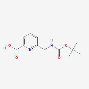 molecular formula C12H16N2O4 B1387228 6-(((tert-Butoxycarbonyl)amino)methyl)picolinic acid CAS No. 171670-07-8