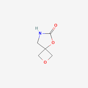 molecular formula C5H7NO3 B13909385 2,5-Dioxa-7-azaspiro[3.4]octan-6-one 