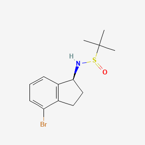 molecular formula C13H18BrNOS B13974605 N-[(1S)-4-bromo-2,3-dihydro-1H-inden-1-yl]-2-methylpropane-2-sulfinamide 