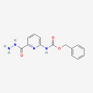 B1400654 Benzyl 6-(hydrazinecarbonyl)pyridin-2-ylcarbamate CAS No. 1262043-89-9