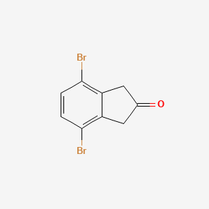 4,7-Dibromoindan-2-one