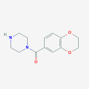 molecular formula C13H16N2O3 B14062835 1-(2,3-Dihydro-1,4-benzodioxin-6-ylcarbonyl)piperazine 