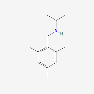molecular formula C13H21N B1414730 (Propan-2-yl)[(2,4,6-trimethylphenyl)methyl]amine CAS No. 1019477-38-3