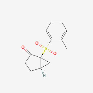 molecular formula C13H14O3S B14196054 (1R,5R)-1-(2-Methylbenzene-1-sulfonyl)bicyclo[3.1.0]hexan-2-one CAS No. 923001-89-2