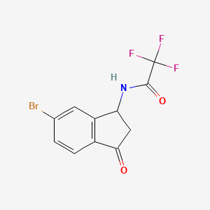 5-Bromo-3-(trifluoroacetamido)indan-1-one