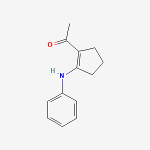 1-(2-Anilinocyclopent-1-en-1-yl)ethan-1-one