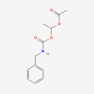 molecular formula C12H15NO4 B14301657 1-[(Benzylcarbamoyl)oxy]ethyl acetate CAS No. 112613-77-1