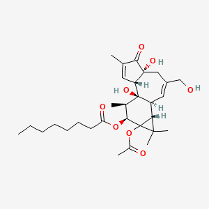 Octanoic acid, 9a-(acetyloxy)-1a,1b,4,4a,5,7a,7b,8,9,9a-decahydro-4a,7b-dihydroxy-3-(hydroxymethyl)-1,1,6,8-tetramethyl-5-oxo-1H-cyclopropa(3,4)benz(1,2-e)azulen-9-yl ester, (1aR-(1aalpha,1bbeta,4abeta,7aalpha,7balpha,8alpha,9beta,9aalpha))-