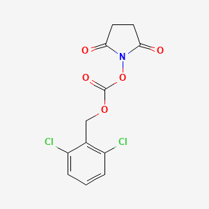 molecular formula C12H9Cl2NO5 B14467621 1-({[(2,6-Dichlorophenyl)methoxy]carbonyl}oxy)pyrrolidine-2,5-dione CAS No. 65853-64-7