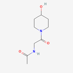 molecular formula C9H16N2O3 B1462563 N-[2-(4-hydroxypiperidin-1-yl)-2-oxoethyl]acetamide CAS No. 1156972-68-7