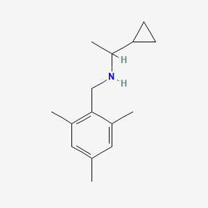 molecular formula C15H23N B1462656 (1-环丙基乙基)[(2,4,6-三甲基苯基)甲基]胺 CAS No. 1155606-85-1