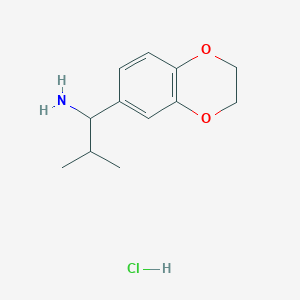 molecular formula C12H18ClNO2 B1471562 1-(2,3-Dihydrobenzo[b][1,4]dioxin-6-yl)-2-methylpropan-1-amine hydrochloride CAS No. 2098129-11-2