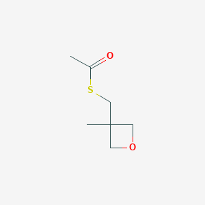 1-{[(3-Methyloxetan-3-yl)methyl]sulfanyl}ethan-1-one