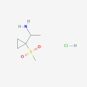 molecular formula C6H14ClNO2S B1475039 1-(1-Methanesulfonylcyclopropyl)ethan-1-amine hydrochloride CAS No. 1803593-06-7