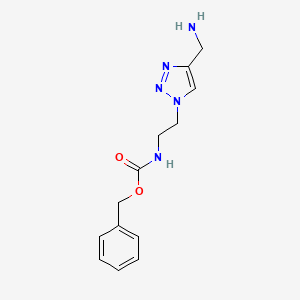 molecular formula C13H17N5O2 B1480614 benzyl (2-(4-(aminomethyl)-1H-1,2,3-triazol-1-yl)ethyl)carbamate CAS No. 2098111-08-9